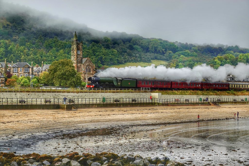 the flying Scotsman passing by Burntisland beach with the beautiful erskine church in the background.